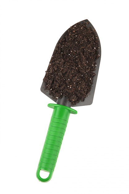 Photo green garden tools shovel and soil isolated on white background