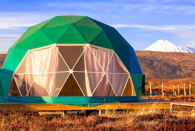 Green geodome tent on kamchatka peninsula cozy camping glamping holiday vacation lifestyle concept o...