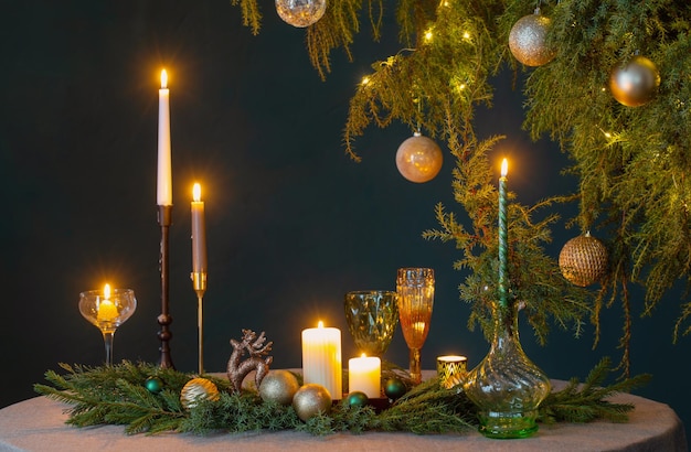 Green and golden christmas decor on table on dark background