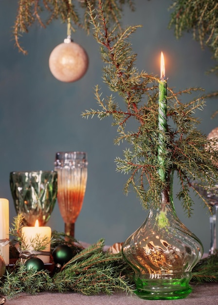 Green and golden christmas decor on table on dark background