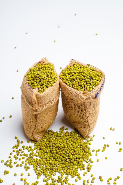 Green gram or mung bean in bag over white background.