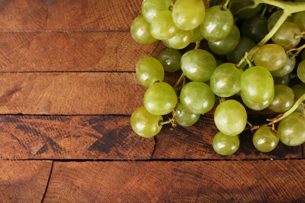 Green grape on wooden background