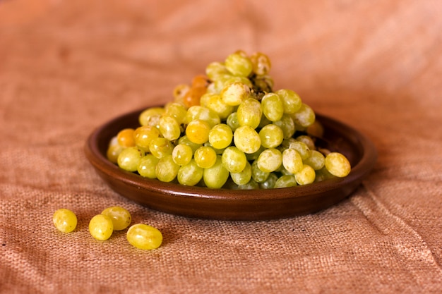 Green grapes on a clay brown dish