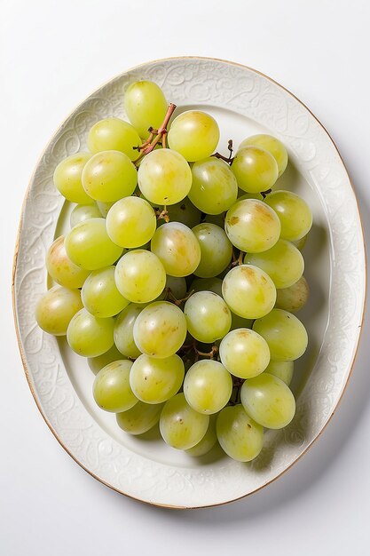 Green grapes in a plate on a white background