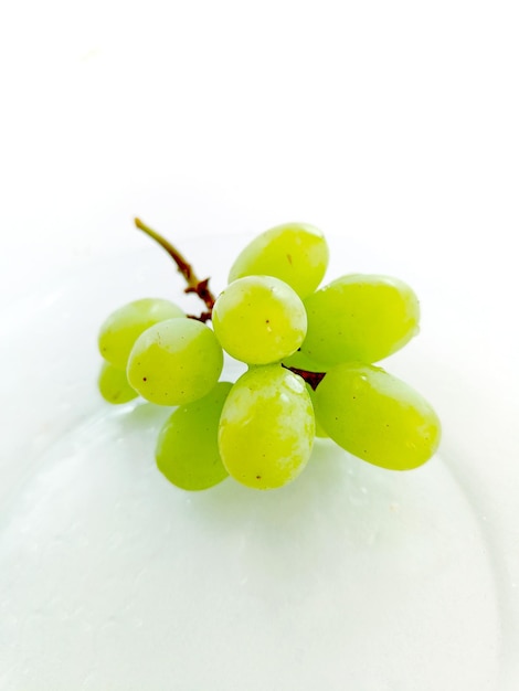 透明な皿の上の緑のブドウ