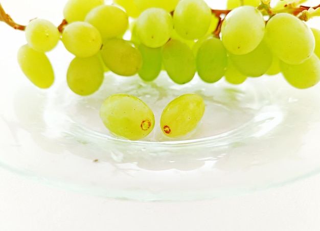 Green grapes on a transparent plate