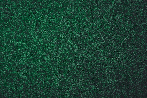緑の芝生のテクスチャ背景。自然ダークグリーントーンの背景色。コピースペース平面図。