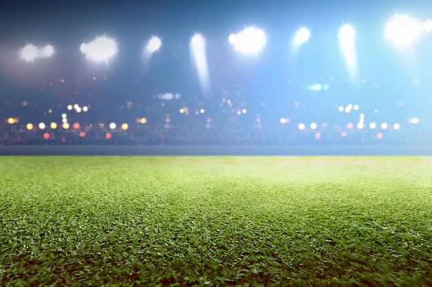 Green grass and tribune with blurred lights