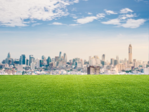 Green grass or turf with cityscape background