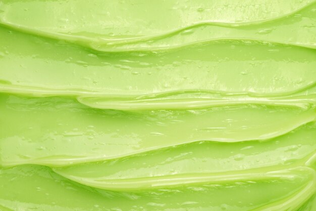 Green hair mask with close-up texture. Abstract background.