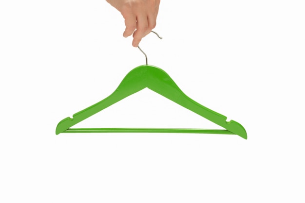 Green hanger in woman hand isolated on white background.