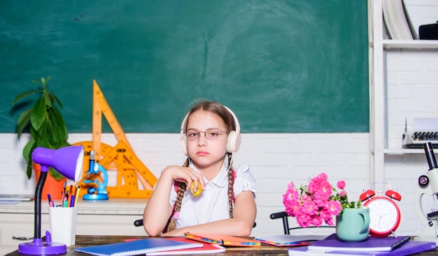 Green healthy food healthy eating is good digital age with modern technology genius child in classroom Lunch time small girl ready to eat apple Smart child concept back to school Einstein