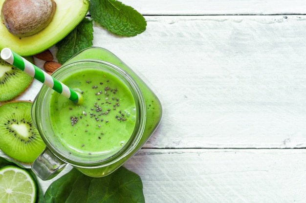 Green healthy smoothie with avocado, spinach, kiwi, lime and chi