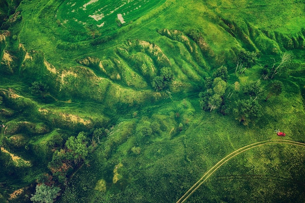 ドローンからの自然な夏の季節の背景の上から見た緑の丘と峡谷