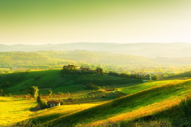 Green hills at sunset in Tuscany Italy Beautiful summer landscape Fields with fresh green grass