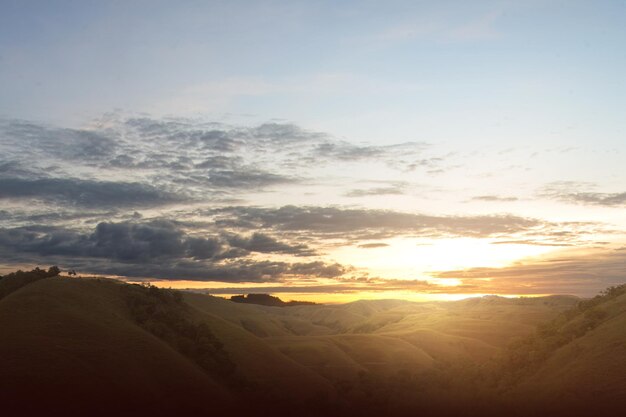 Green hills with landscape view with a sunrise sky background