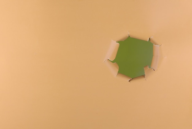 green hole on yellow paper background