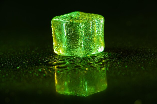 Green ice cubes on black background