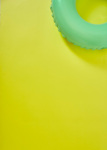 Green Inflatable Ring on yellow background