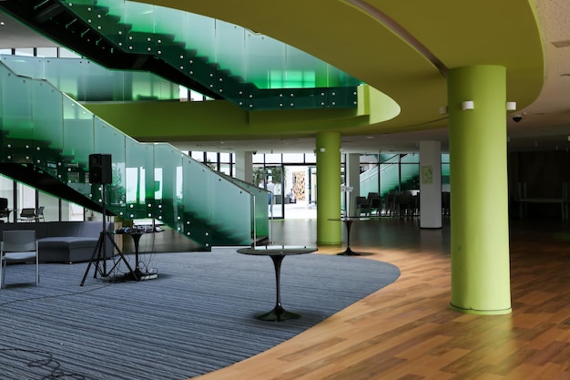 Green interior with glass stairs and columns