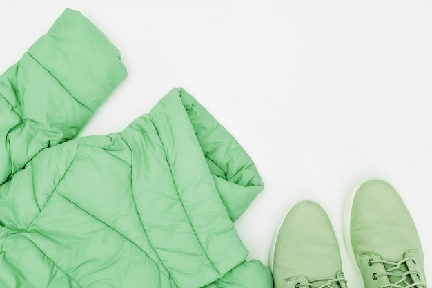 Green jacket and boots on a white background