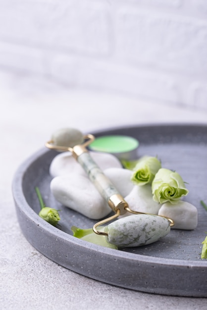 Green jade facial roller for massaging and skincare