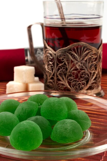 Green jelly sweets on a glass saucer