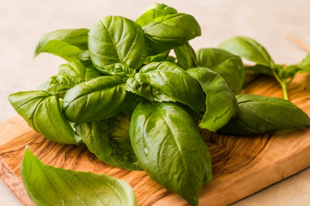 Green leafs of genovese basil on board