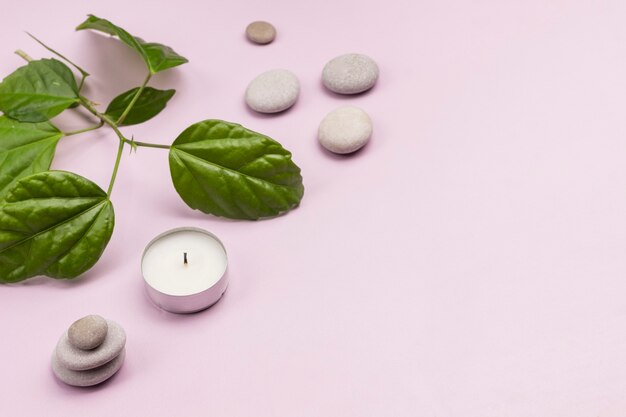 Green leaves, candle, Stone balance pyramid