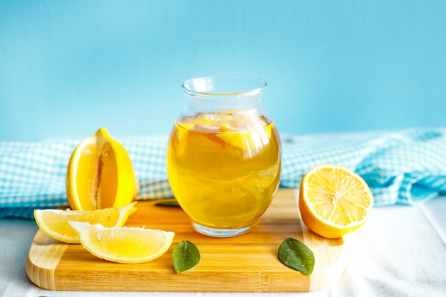 Green lemon tea with a tablecloth and lemon fruit 