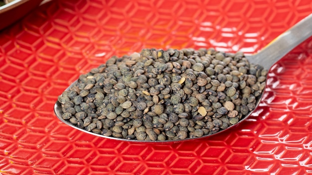 Green lentils in a spoon