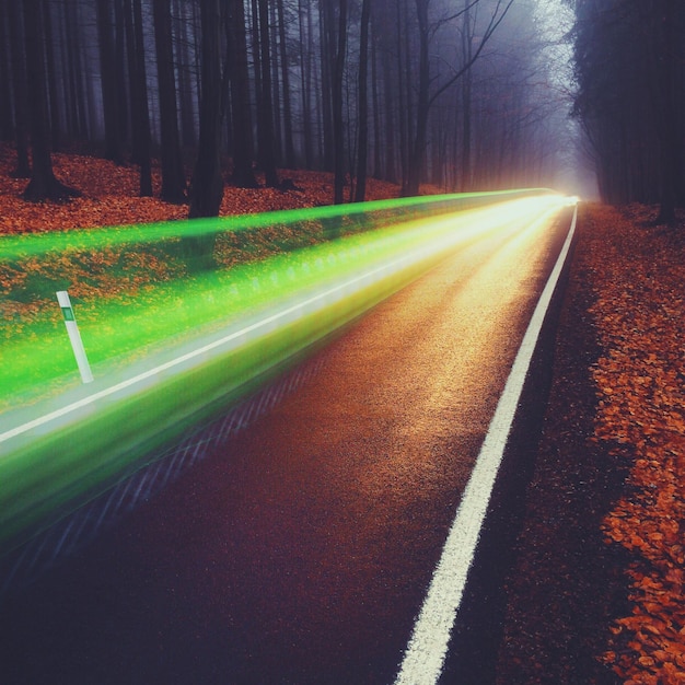 Photo green light trails over street