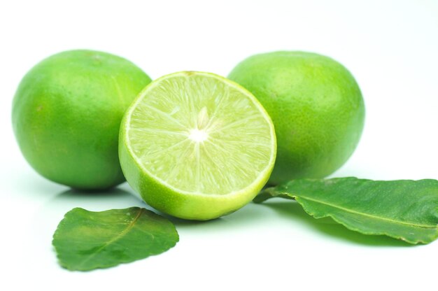 green lime with leaves isolated on white background