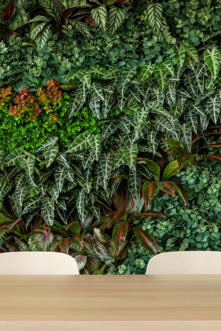 Green living room with chairs and table vertical garden stock photo