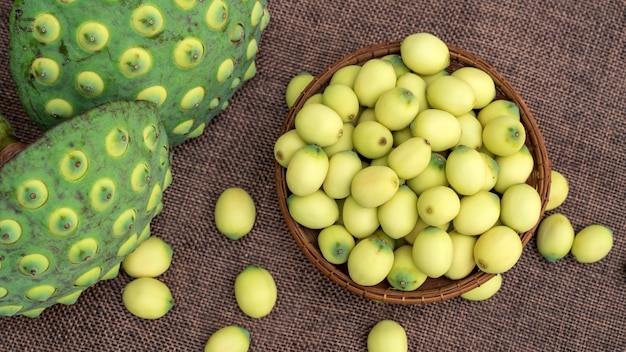 Green lotus seeds on a wooden table.