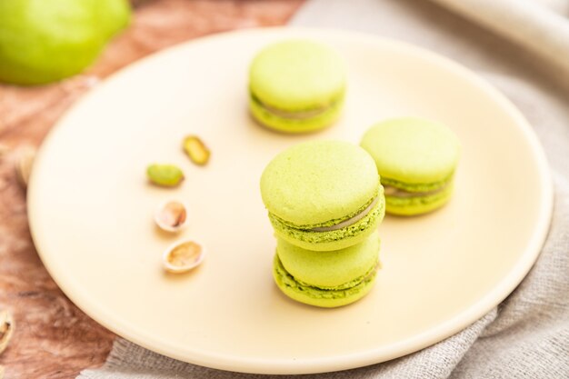 Green macarons or macaroons cakes with cup of coffee