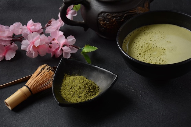 Green matcha tea drink and tea accessories on white background. Japanese tea ceremony concept. Detox tea. Antioxidant drink