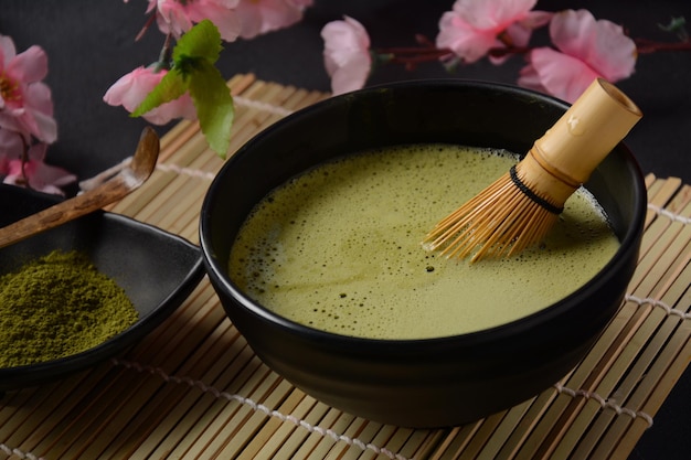 白地に緑の抹茶ドリンクとお茶のアクセサリー。日本の茶道のコンセプト。デトックスティー。抗酸化ドリンク
