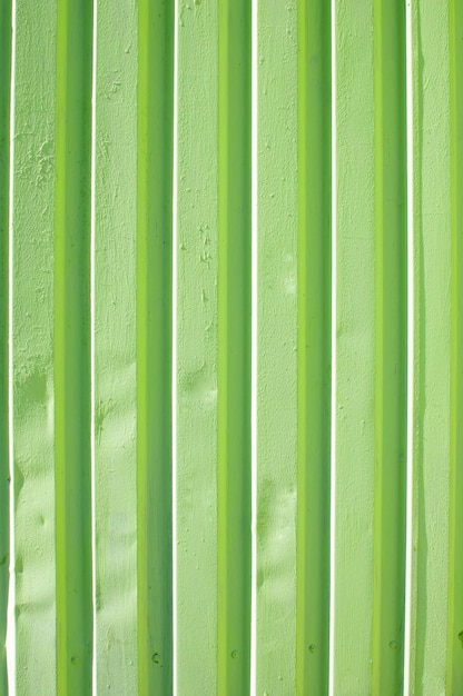 Green metal fence wall texture with lines abstract background vertical