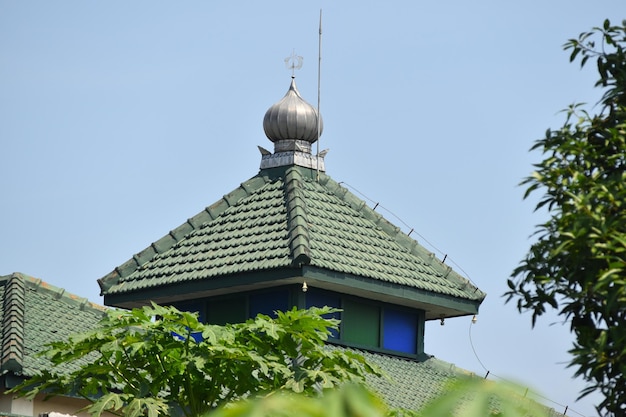 Green mosque roof in a village