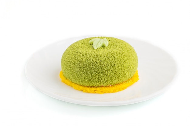 Green mousse cake with pistachio and strawberry cream isolated. side view.