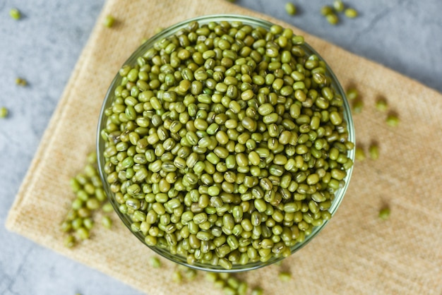 Green mung beans in bowl on gray background - Mung bean seed cereal whole grains