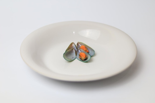 Green Mussels on a plate with a white background