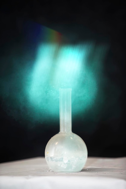 A green mystical light comes from the chemical flask