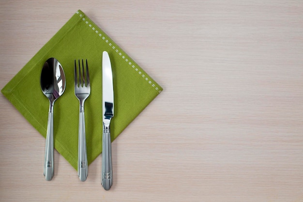 Photo green napkin knife fork