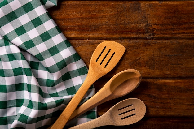 Green napkin with spoon on the table.