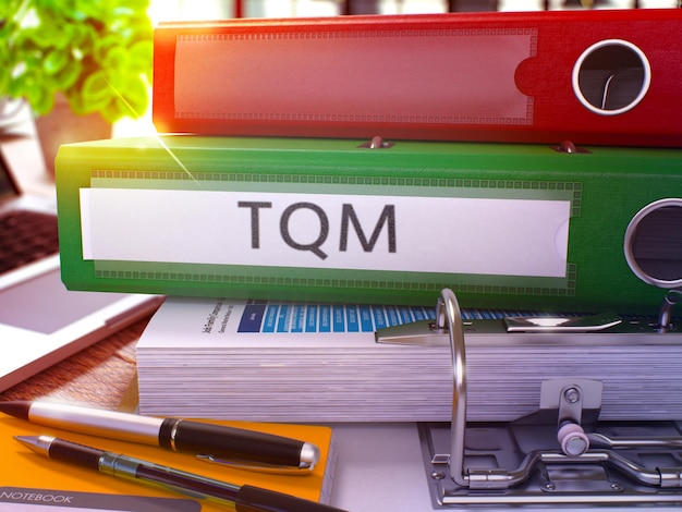 Photo green office folder with inscription tqm