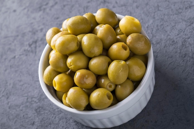 Green olives in a bowl Closeup