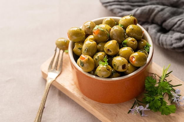 Green olives in a bowl Delicious marinated olives