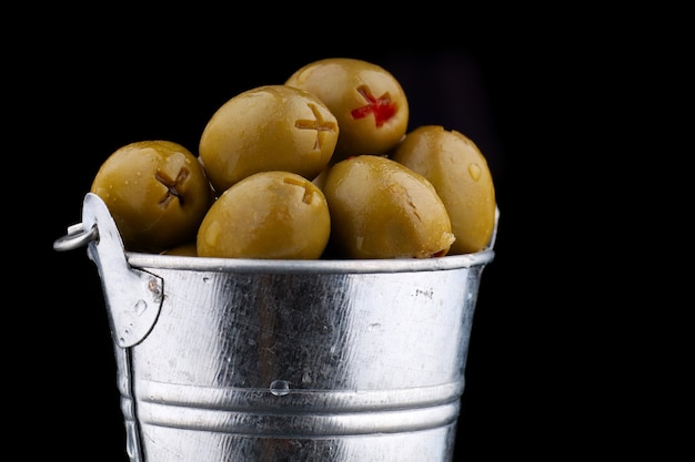 Green olives stuffed in a bucket